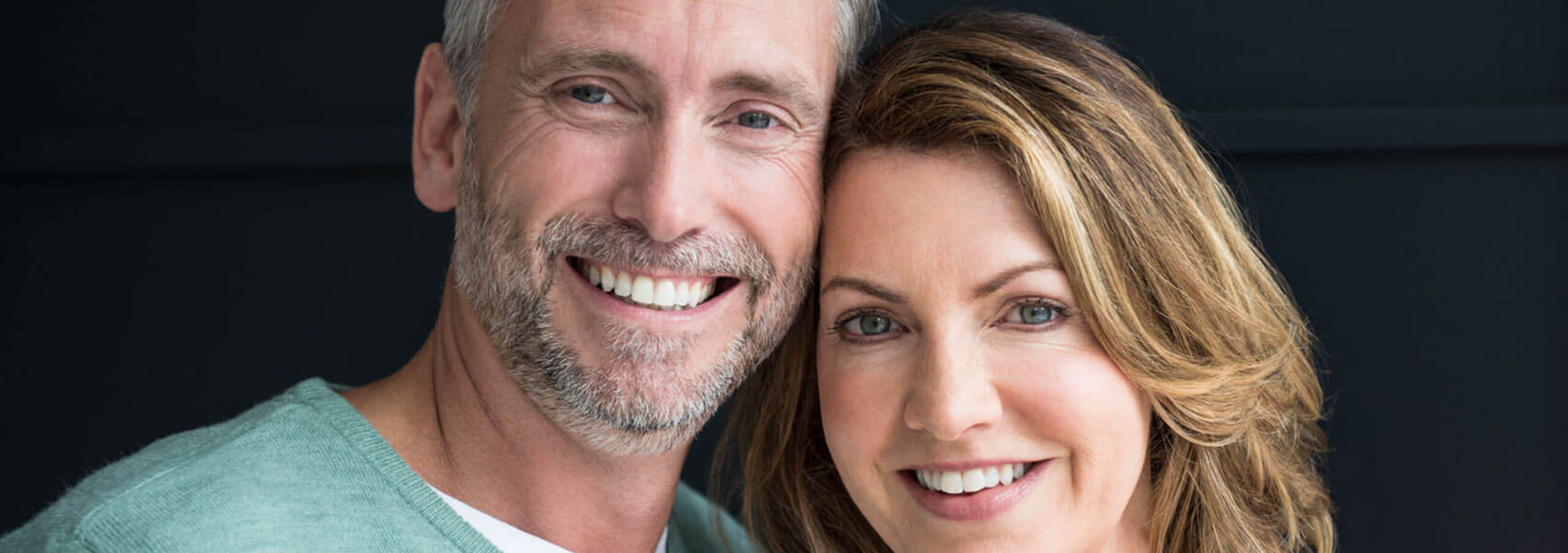 couple smiling with their heads against each others