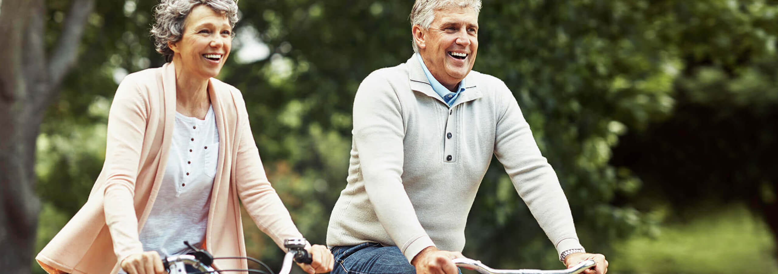 an adult couple riding their bikes outside