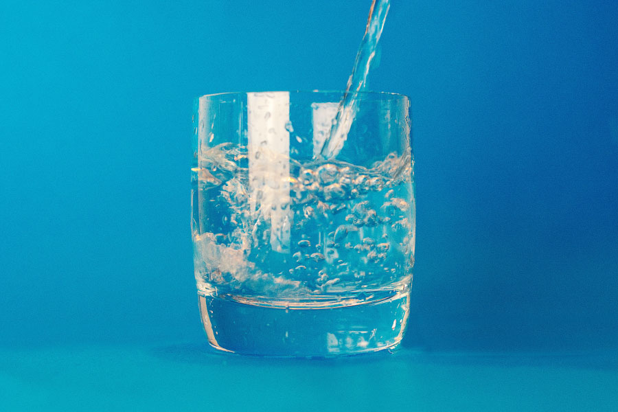 Glass of water representing a saltwater rinse.