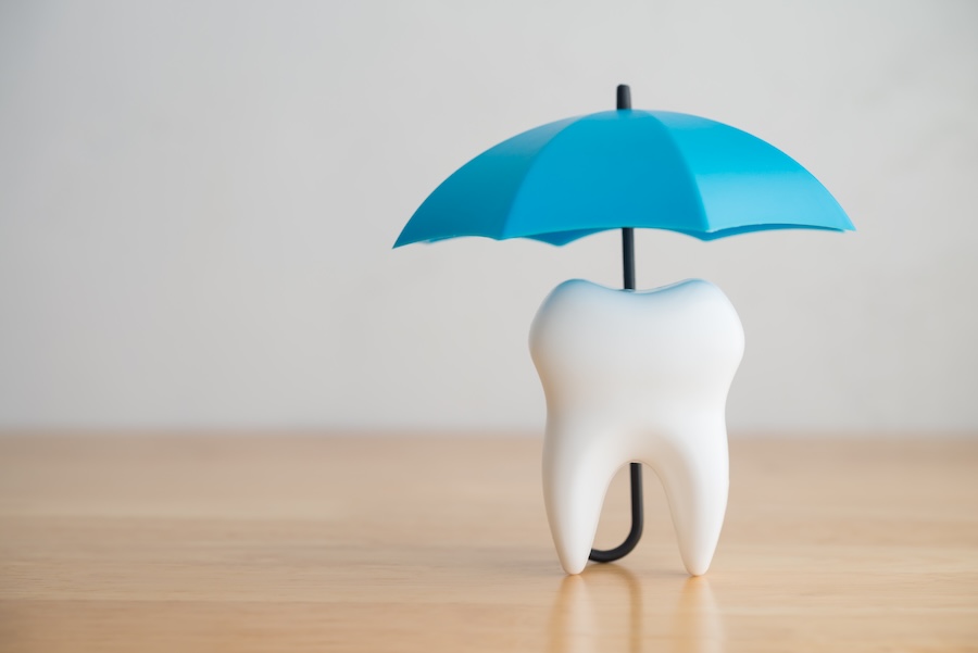in network and out of network dental insurance provider, tooth under an umbrella